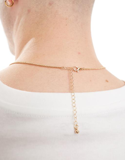 ASOS DESIGN cross pendant with design in gold tone