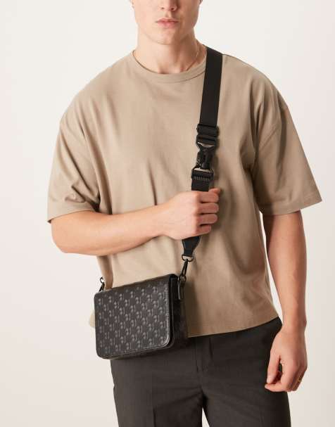 ASOS DESIGN crossbody bag with monogram emboss detail in black faux leather - view 1