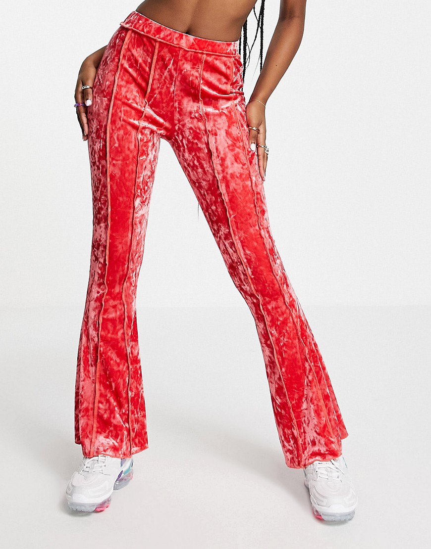 ASOS DESIGN crushed velvet flare pant with exposed seams in pink