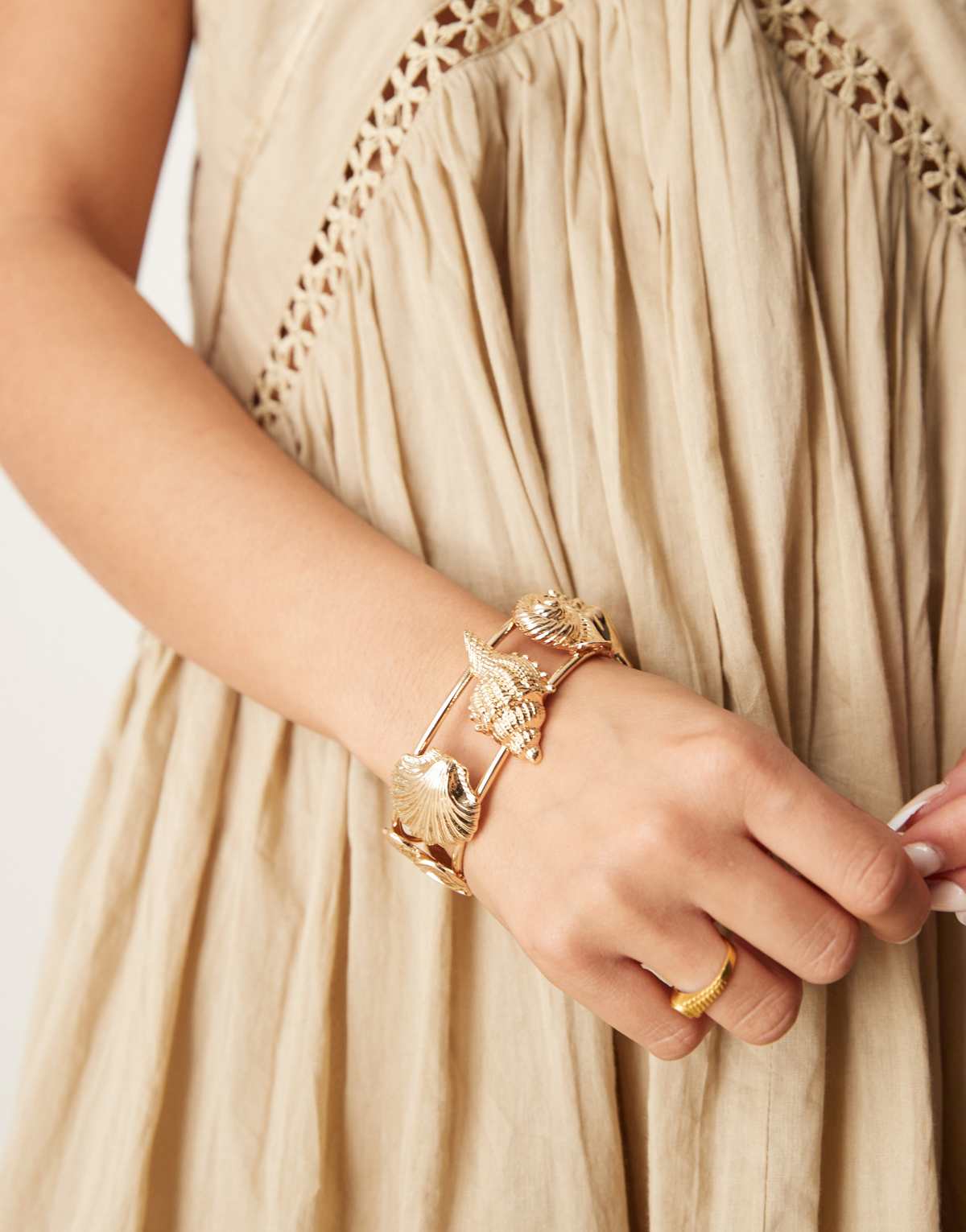 ASOS DESIGN cuff bracelet in mixed shell design in gold tone