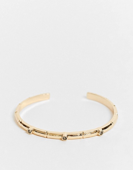 ASOS DESIGN cuff bracelet with bamboo and black stone detail in gold tone