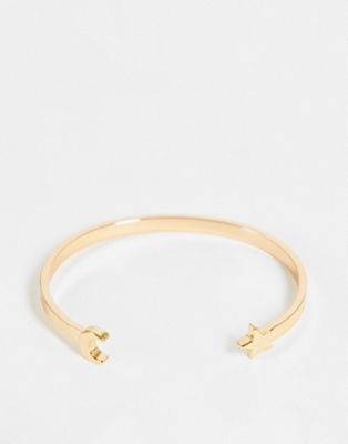 ASOS DESIGN cuff bracelet with star and moon design in gold tone