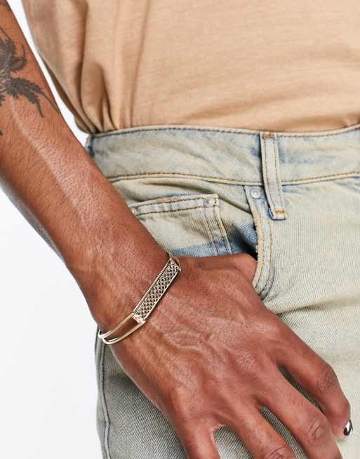 ASOS DESIGN cuff bracelet with tab and cross hatch emboss in gold tone