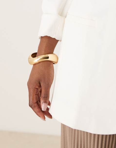 ASOS DESIGN cuff bracelet with twist design in gold - view 1