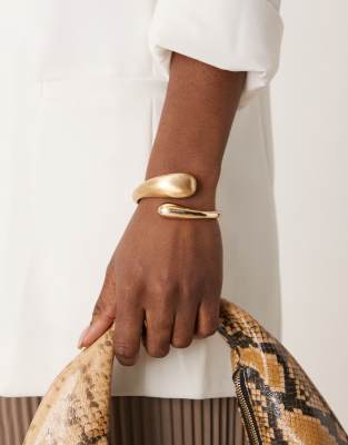 cuff bracelet with wrap around molten detail with shiny and brushed gold tone