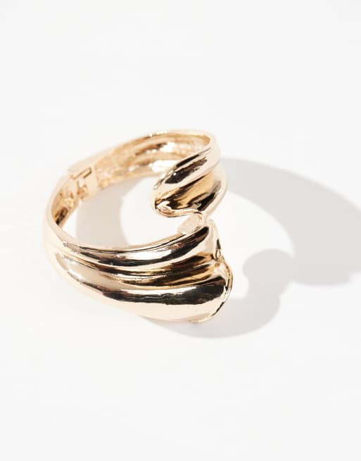 ASOS DESIGN cuff bracelet with wraparound abstract detail in gold tone, 3 of 4