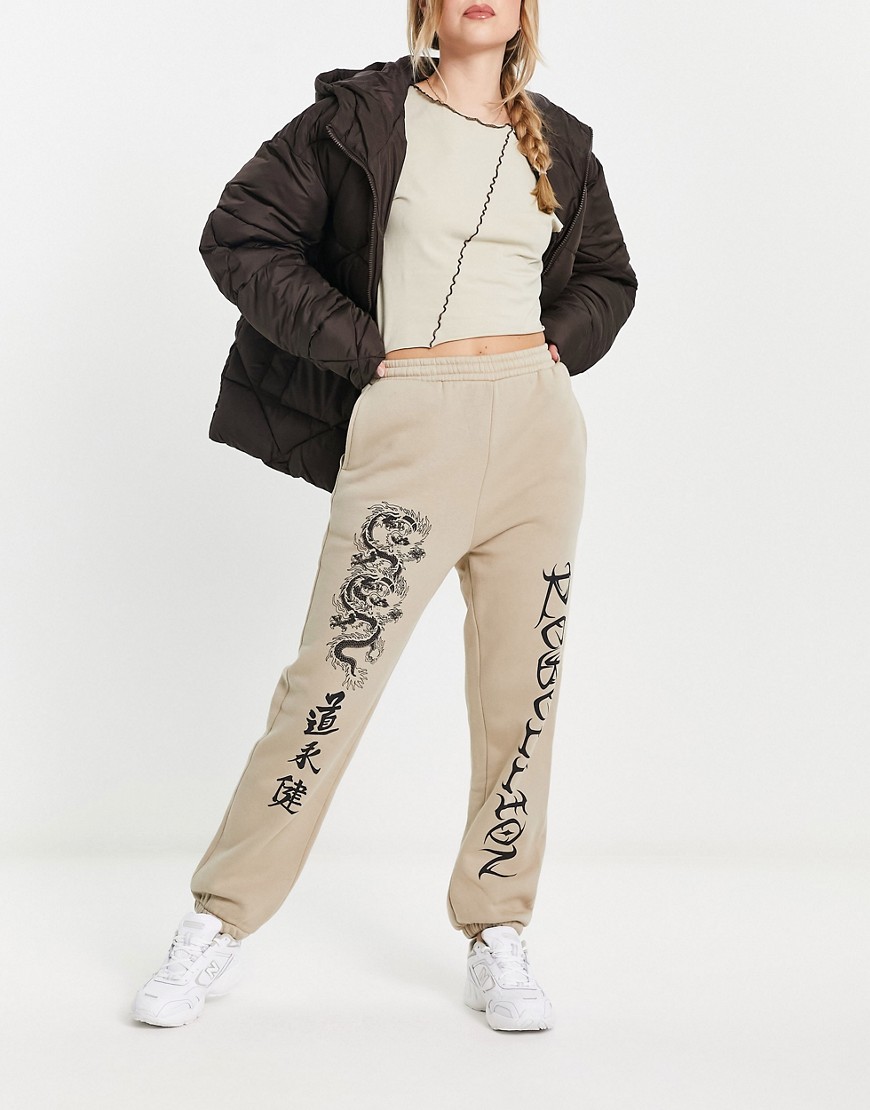 ASOS DESIGN cuffed jogger with dragon graphic in stone-Neutral