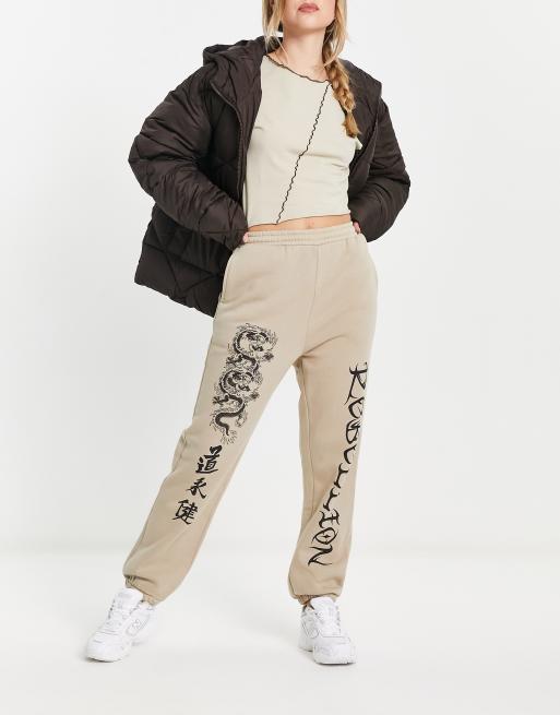 ASOS DESIGN cuffed jogger with dragon graphic in stone