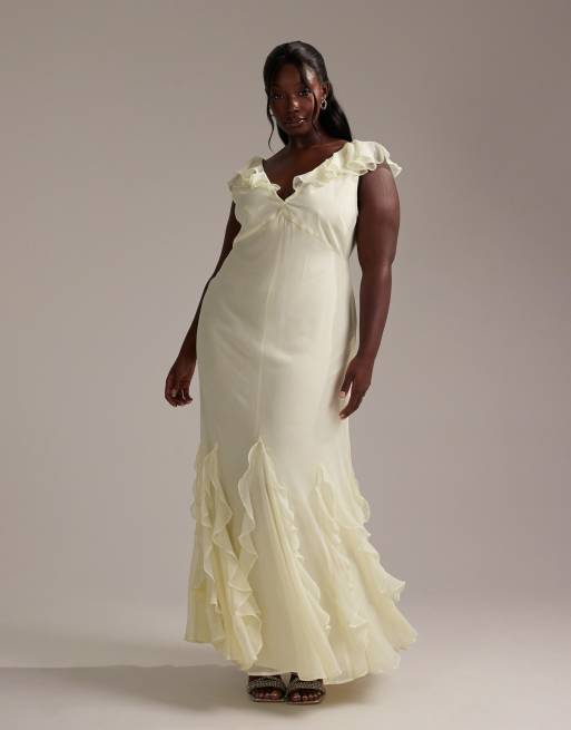 ASOS DESIGN Curve - Bruidsmeisjes - Schuingesneden maxi-jurk met fladdermouwen en godetplooien met ruches in zachtgeel