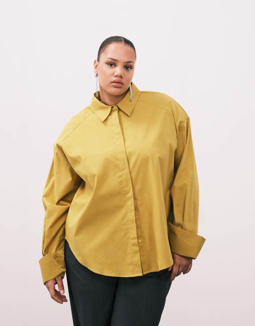 ASOS DESIGN Curve - Camicia color senape con taglio asimmetrico e spalline imbottite