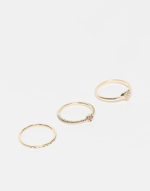 ASOS DESIGN Curve - Confezione da 3 anelli color oro con cristalli scintillanti rosa a forma di cuore