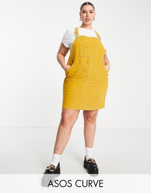 ASOS DESIGN Curve - Corduroy overgooierjurk in donkergeel