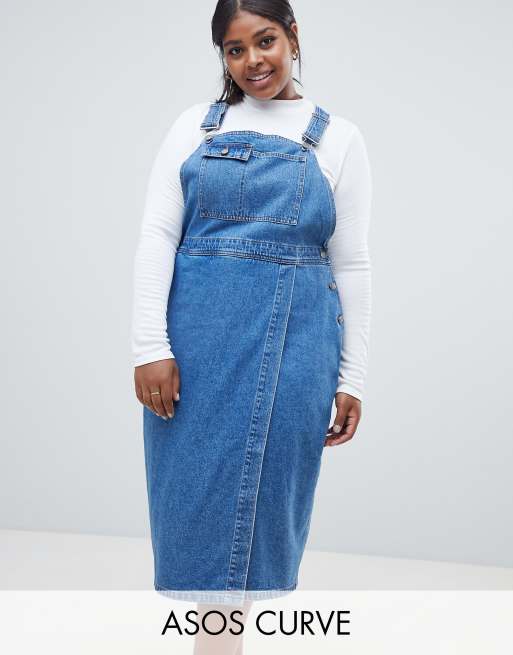 ASOS DESIGN Curve denim midi dungaree dress in midwash blue