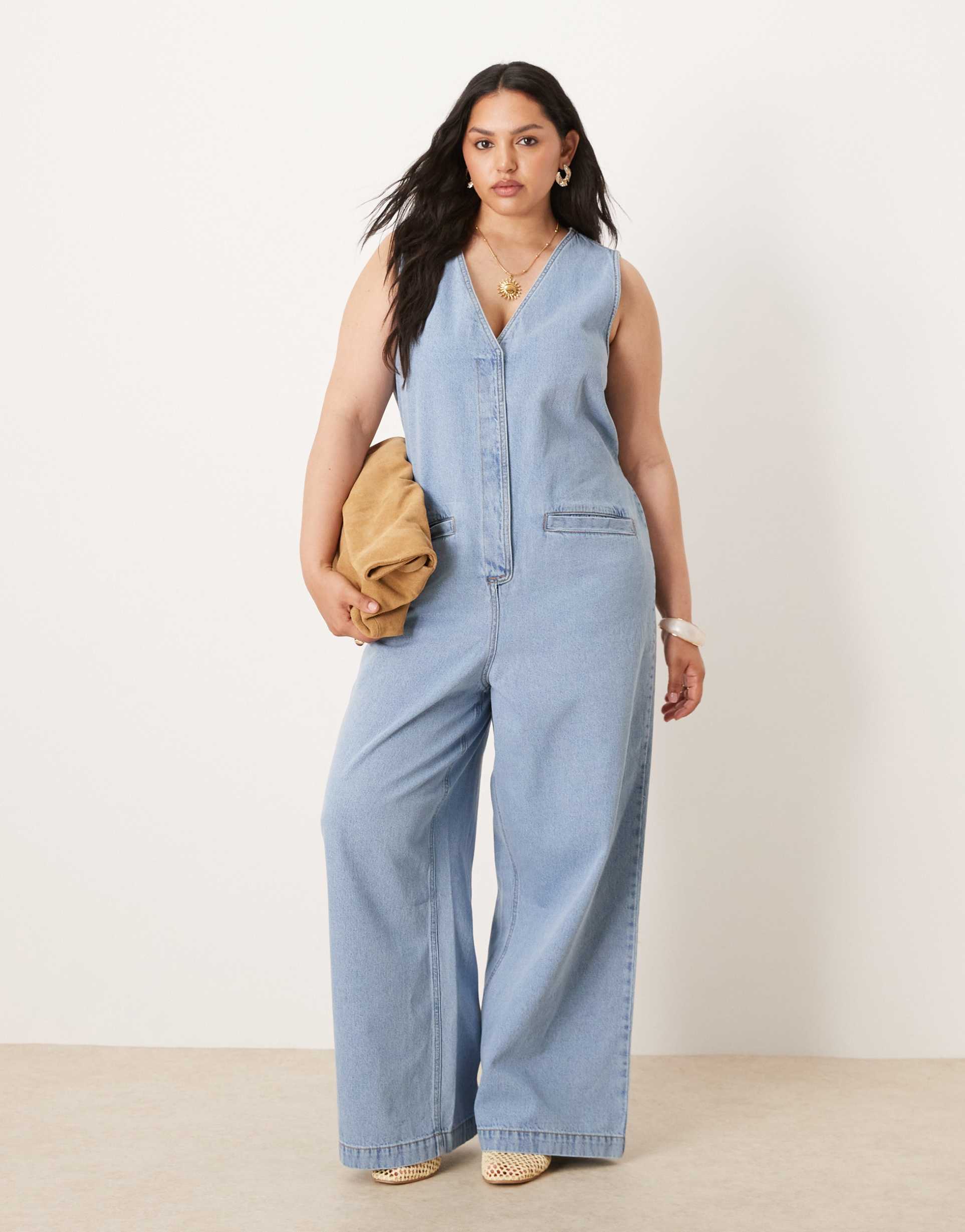 asos design curve denim sleeveless jumpsuit with tie back in light wash blue
