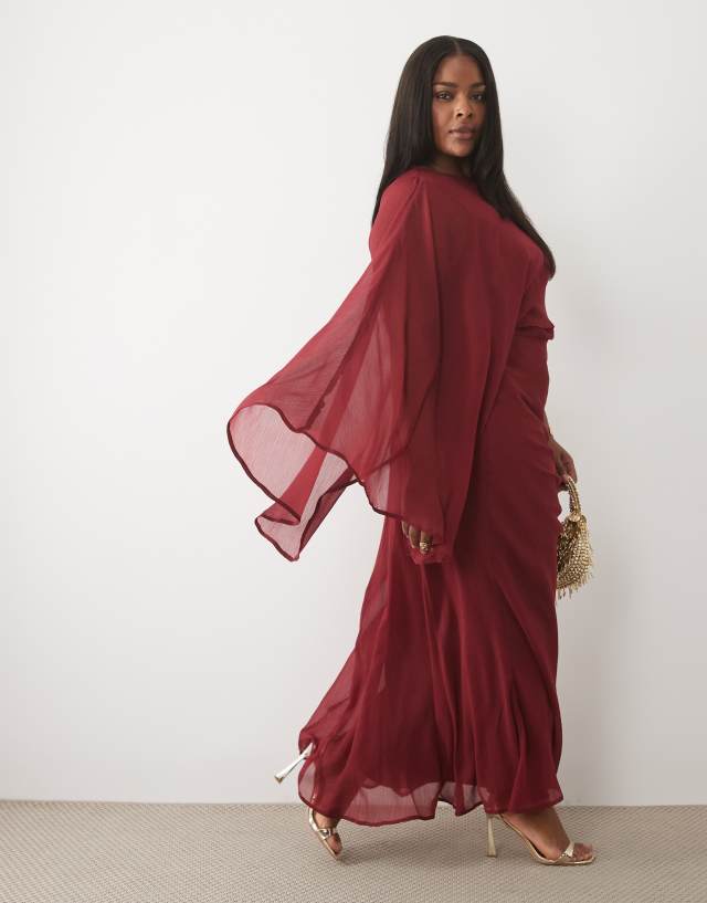 ASOS DESIGN Curve draped batwing asymmetric one sleeve maxi dress in burgundy