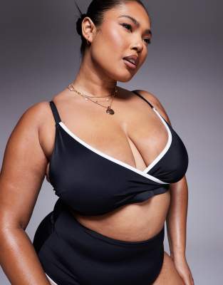 ASOS DESIGN Curve - Exklusives schmales kurzes Bikinioberteil in Schwarz mit Kontrasteinfassung