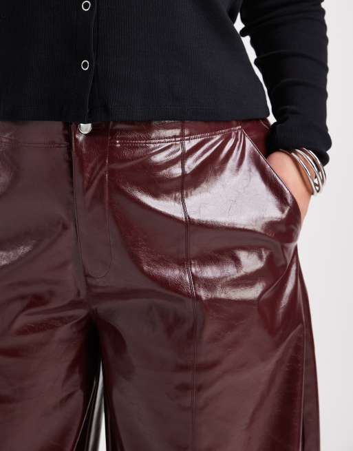 ASOS DESIGN Curve faux leather barrel leg pants with tab detail in burgundy