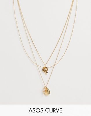 ASOS DESIGN – Curve – Guldfärgat halsband med kedjor i flera rader och gardenior och amor