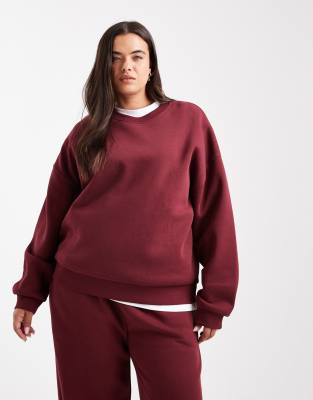 ASOS Curve ASOS DESIGN Curve oversized brushback sweatshirt with raglan detail in burgundy-Red