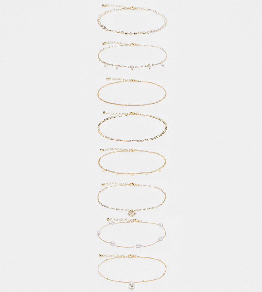 ASOS DESIGN Curve pack of 8 anklets with mixed chain and faux pearl design in gold tone