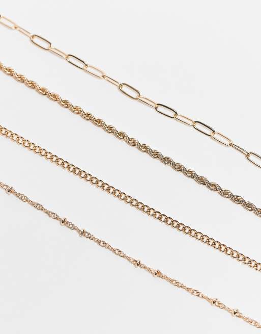 ASOS DESIGN Curve - Set van 4 fijne schakelarmbanden in goudkleur, 2 van 3