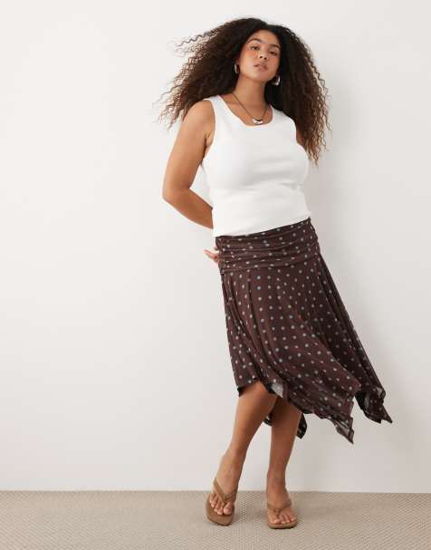 ASOS DESIGN Curve sheer mesh hanky hem skirt in brown polka dot