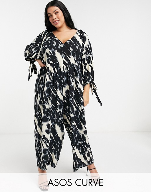 ASOS DESIGN curve smock jumpsuit with tie sleeve detail in blurred animal print