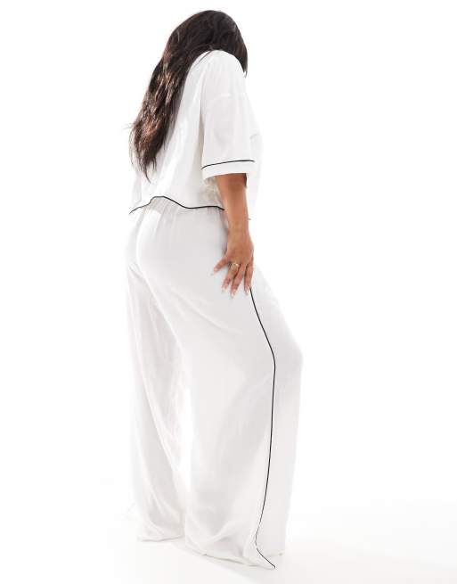 ASOS DESIGN Curve super soft slinky wide leg pajama pants in white with contrast binding