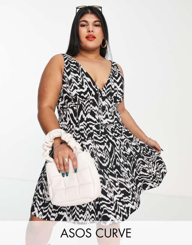 ASOS DESIGN Curve tiered sundress with button waist detail in black and cream abstract print