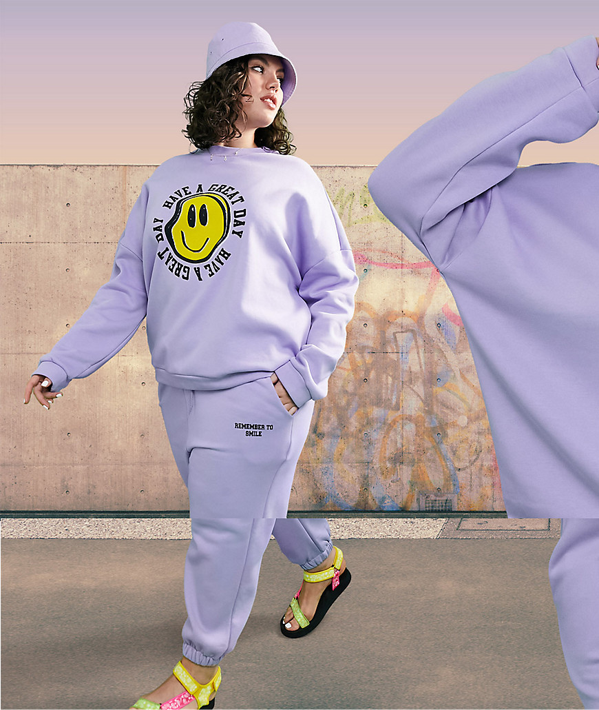 ASOS DESIGN Curve tracksuit oversized sweat /oversized sweatpants with happyface graphic in lilac-Purple
