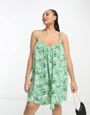 ASOS DESIGN Curve - Trapezförmiges Minikleid mit Trägern zum Binden und großem Kachelmuster in Grün-Bunt