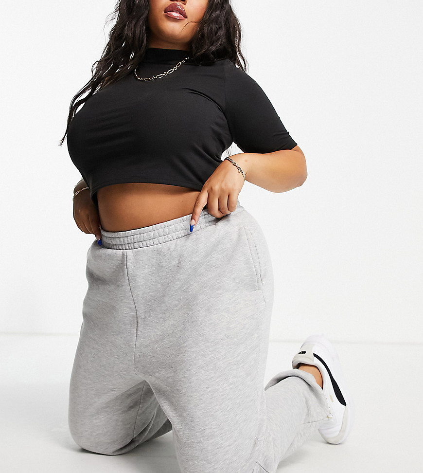 Plus-size joggers by ASOS DESIGN Part of our responsible edit High rise Elasticated waist Side pockets Elasticated cuffs Regular, tapered fit