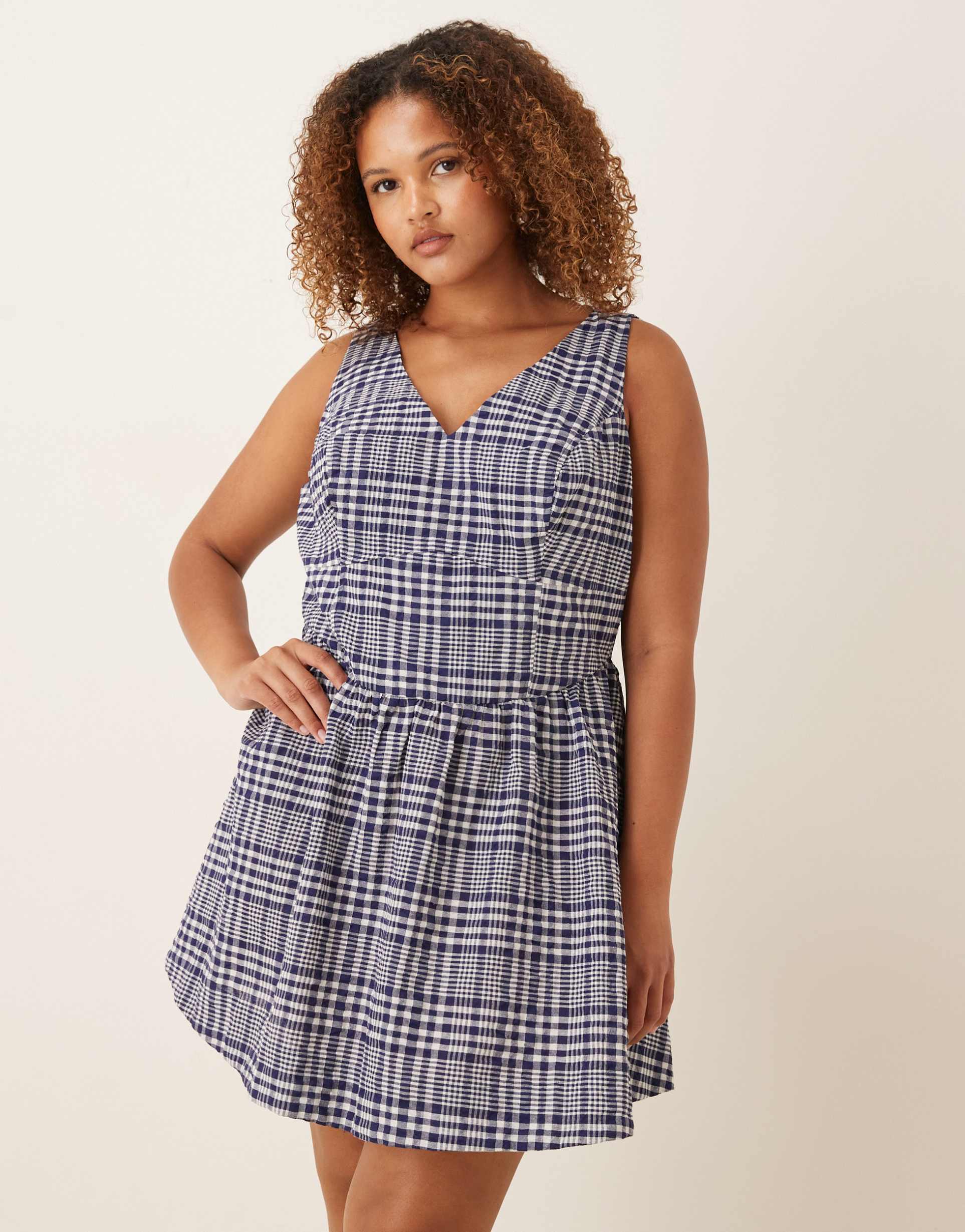 asos design curve waisted v-neck mini sundress with seaming details in navy gingham