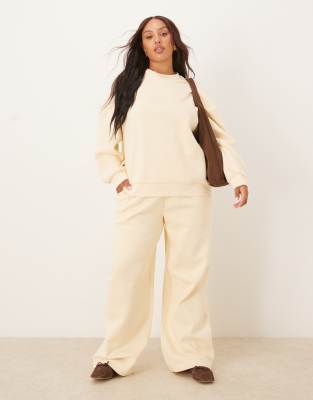 ASOS DESIGN Curve - Weit geschnittene Jogginghose in sanftem Gelb mit weicher Innenseite