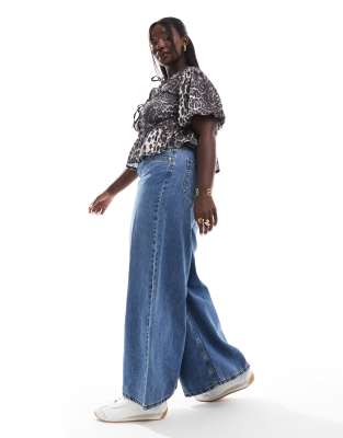ASOS DESIGN Curve wide leg jeans in mid blue