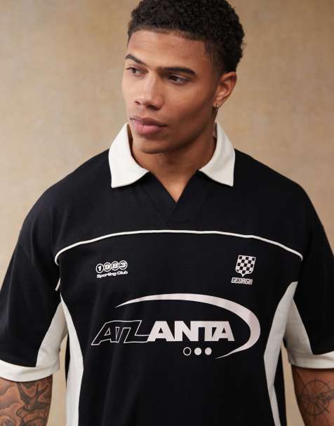 ASOS DESIGN oversized polo with cut and sew panelling and sports graphics in black