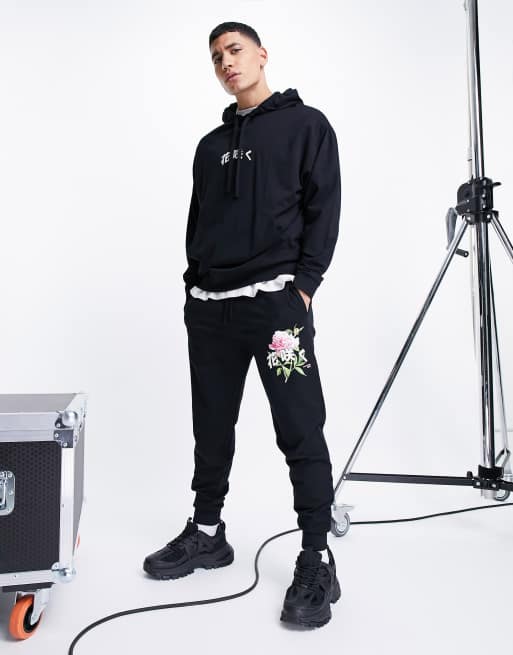 ASOS DESIGN – Czarne dopasowane joggersy z nadrukiem kwiatów, część zestawu – BLACK – BLACK