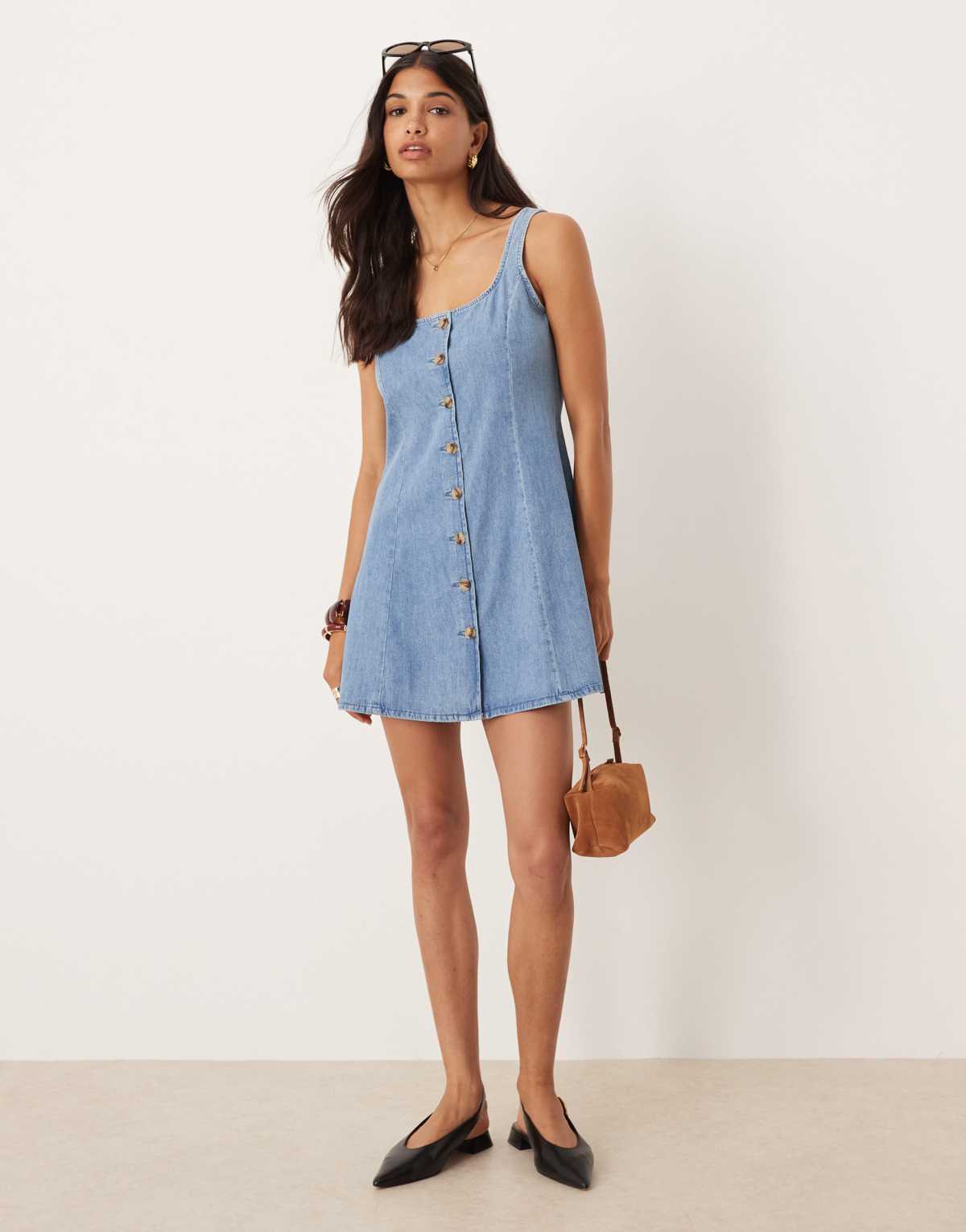ASOS DESIGN denim button through flippy mini dress in light blue wash