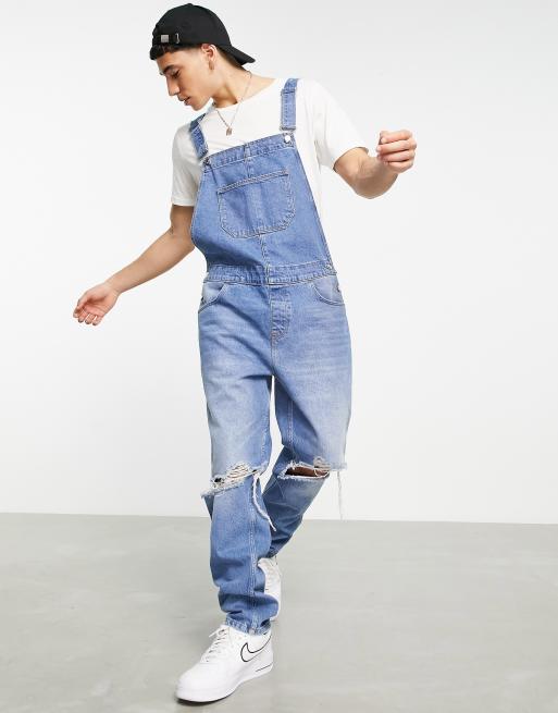 ASOS DESIGN denim dungaree in mid wash with knee rips