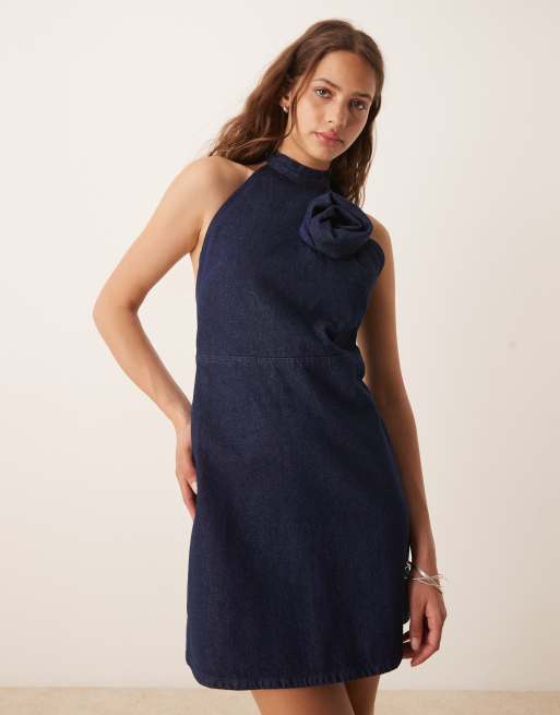 ASOS DESIGN denim halterneck mini dress with rose corsage