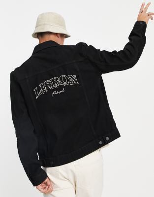 black denim jacket with design on the back