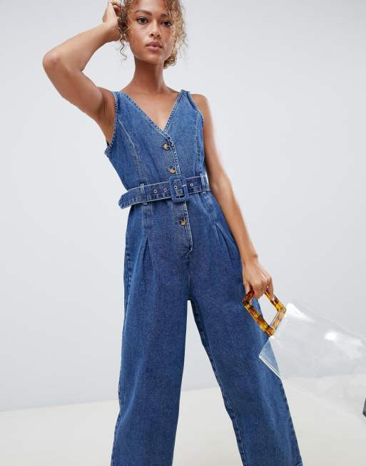 ASOS DESIGN - Denim jumpsuit met knopen in middenblauwe wassing