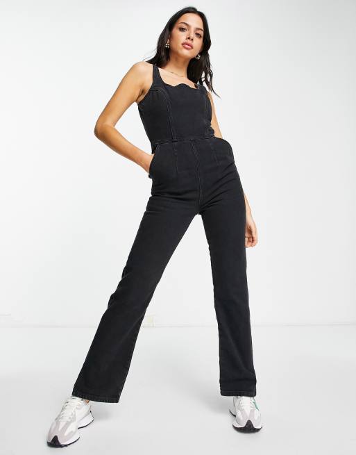 ASOS DESIGN Denim jumpsuit with puddle hem in black