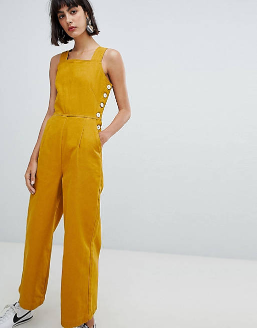 ASOS DESIGN denim jumpsuit with side buttons in mustard