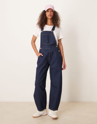 ASOS DESIGN - Denim-Latzhose in Indigoblau mit abgerundetem Beinschnitt-Marineblau