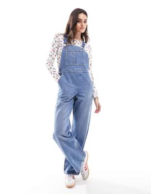 denim overalls in mid blue