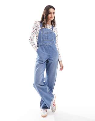 Shop Asos Design Denim Overalls In Mid Blue