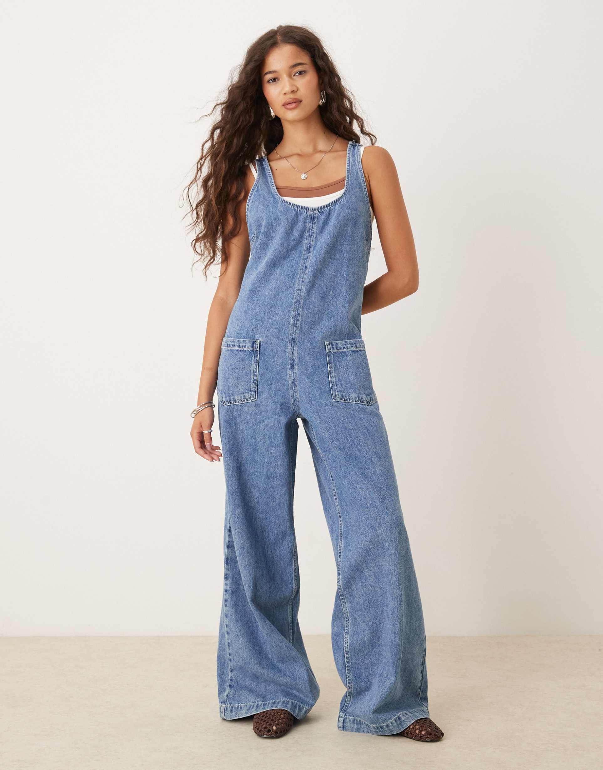 asos design denim overalls jumpsuit with cross back in mid wash