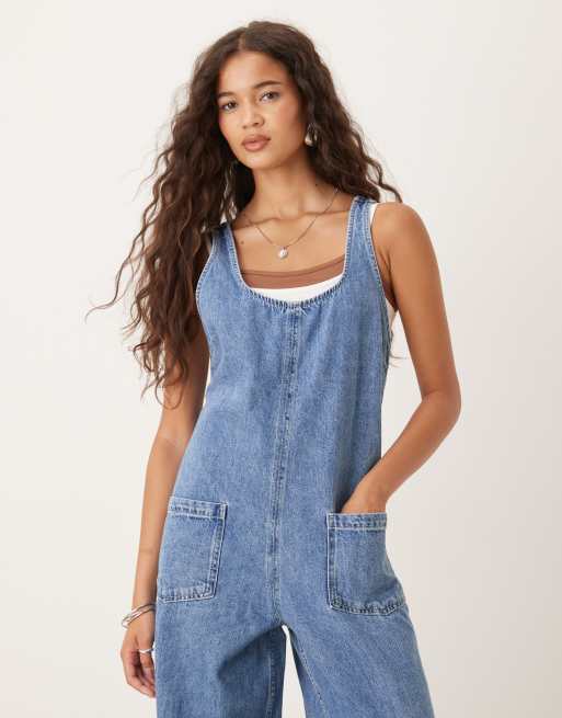 ASOS DESIGN denim overalls jumpsuit with cross back in mid