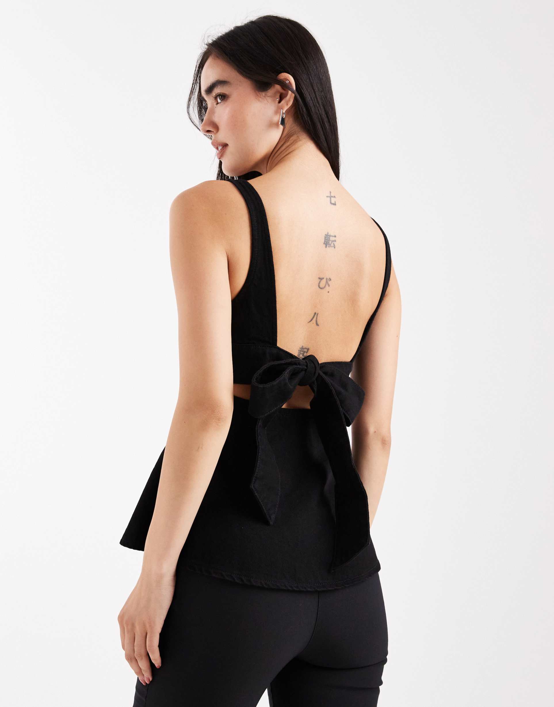 asos design denim peplum top with bow back detail in washed black